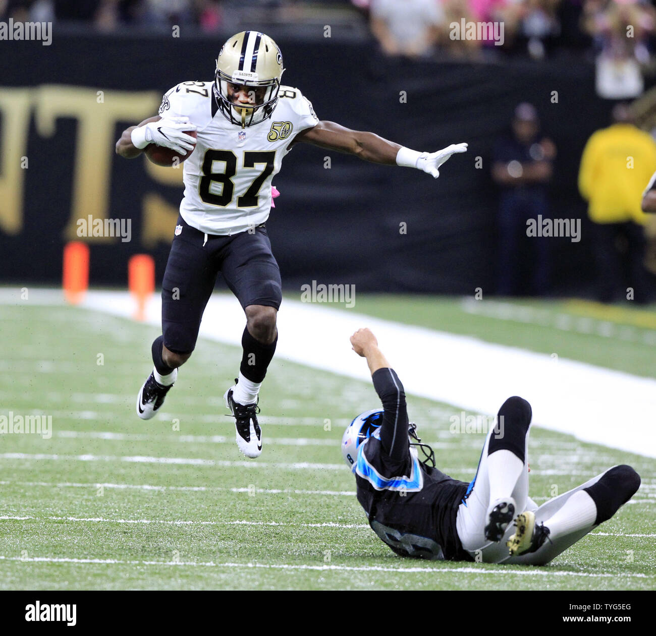 New Orleans Saints wide receiver Tommylee Lewis (87) returns a punt 57  yards before Carolina Panthers punter Andy Lee (8) can trip him up at the  Mercedes-Benz Superdome in New Orleans October