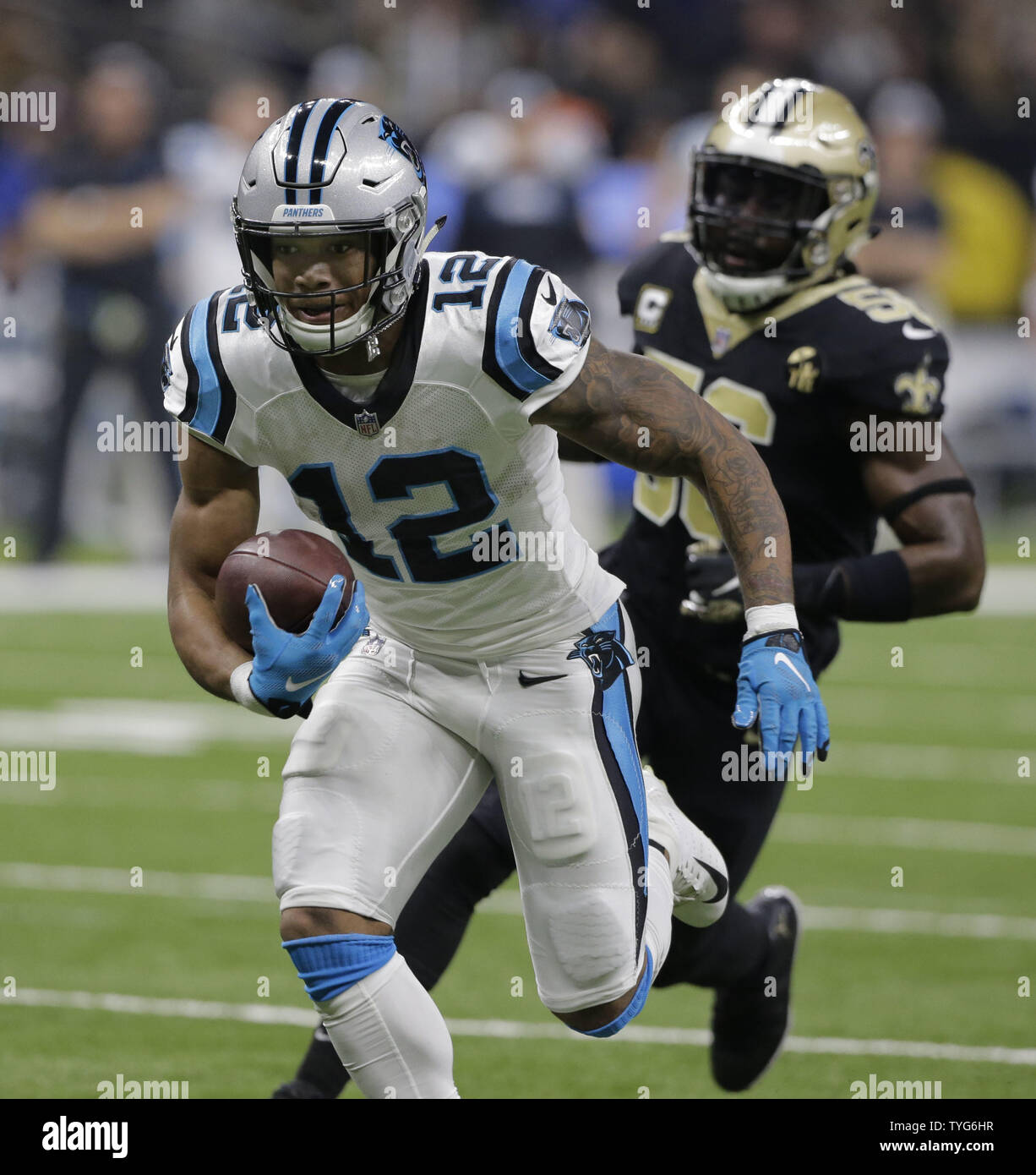 Carolina Panthers wide receiver D.J. Moore (12) takes a Kyle Allen pass 20  yards foe a touchdown against the New Orleans Saints at the Mercedes-Benz  Superdome in New Orleans December 30, 2018.