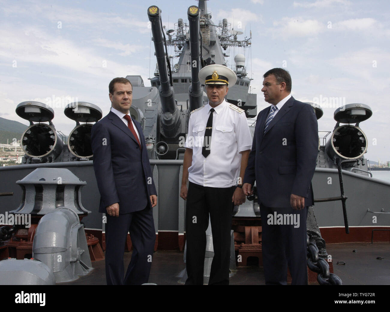 Russian President Dmitry Medvedev (L) and Defense Minister Anatoly Serdyukov (R) listen to Captain Sergei Tronev of the missile cruiser Moskva in Novorossiysk on Black Sea on July 14, 2009. (UPI Photo/Anatoli Zhdanov) Stock Photo