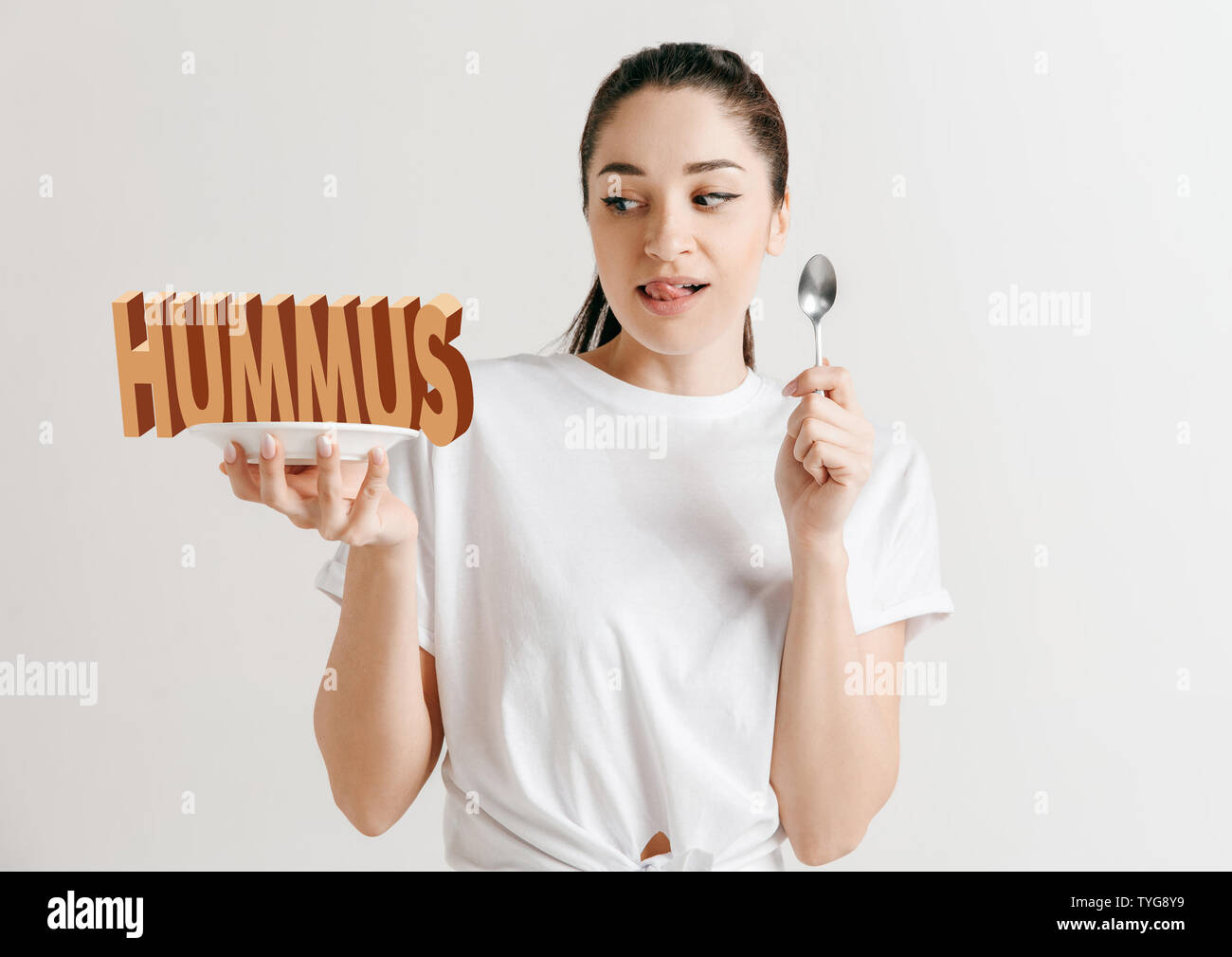 Woman in shirt with the folk isolated on white. Female model holding a ...