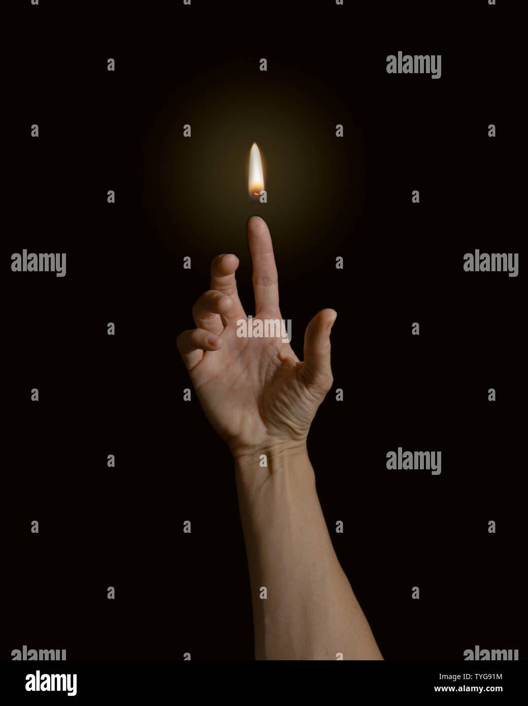The power of mankind. A finger with a flame. Stock Photo