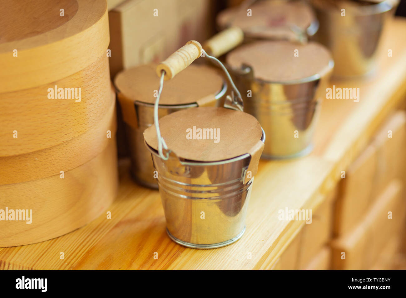 Decorative metal buckets standing on a shop shelf Stock Photo Alamy