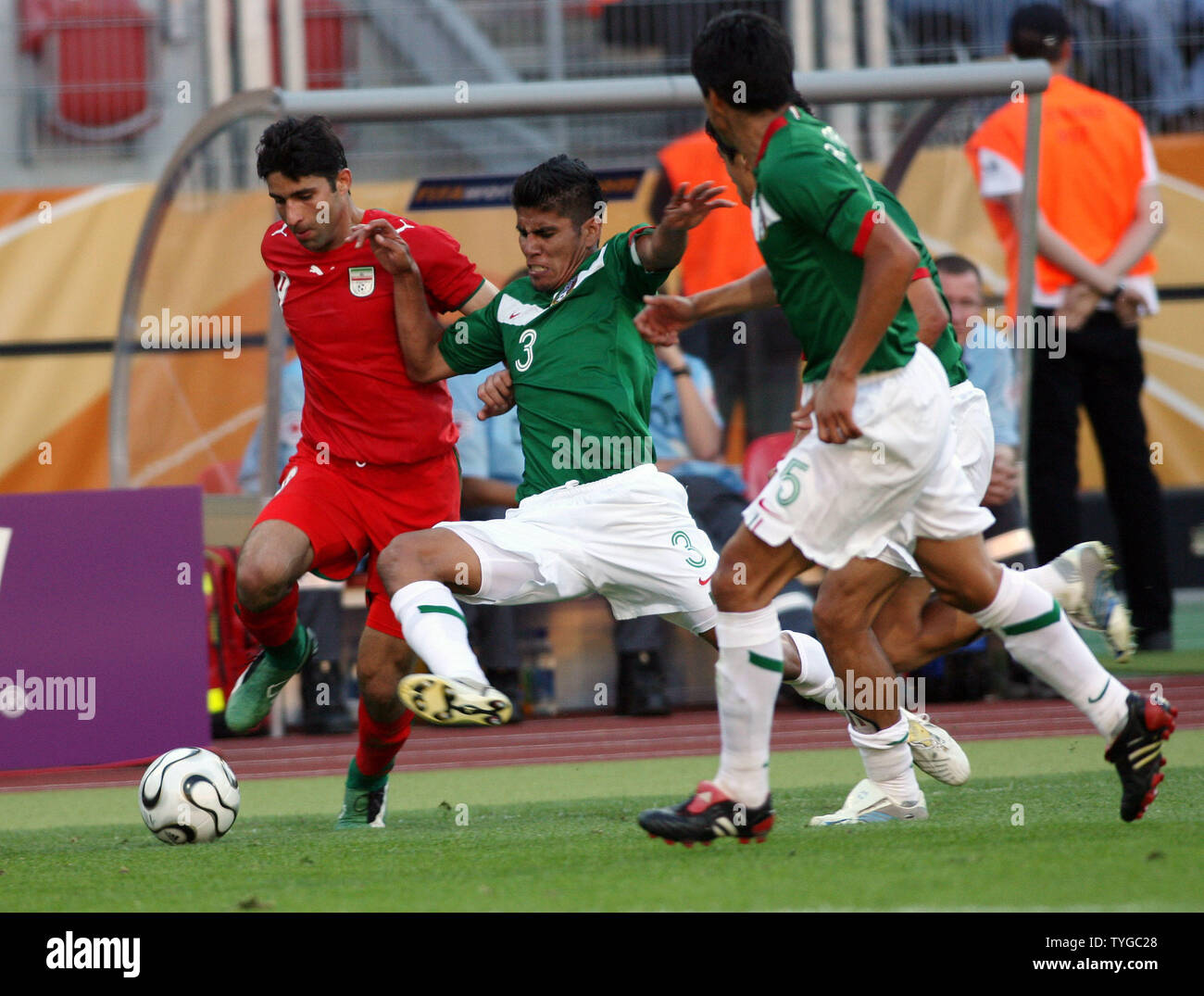 Iranian players fight with Mexican Carlos Salcido (3) in a World Cup match held in Nuernberg on June 11, 2006.  Mexico won 3-1     (UPI  Photo/Arthur Thill) Stock Photo