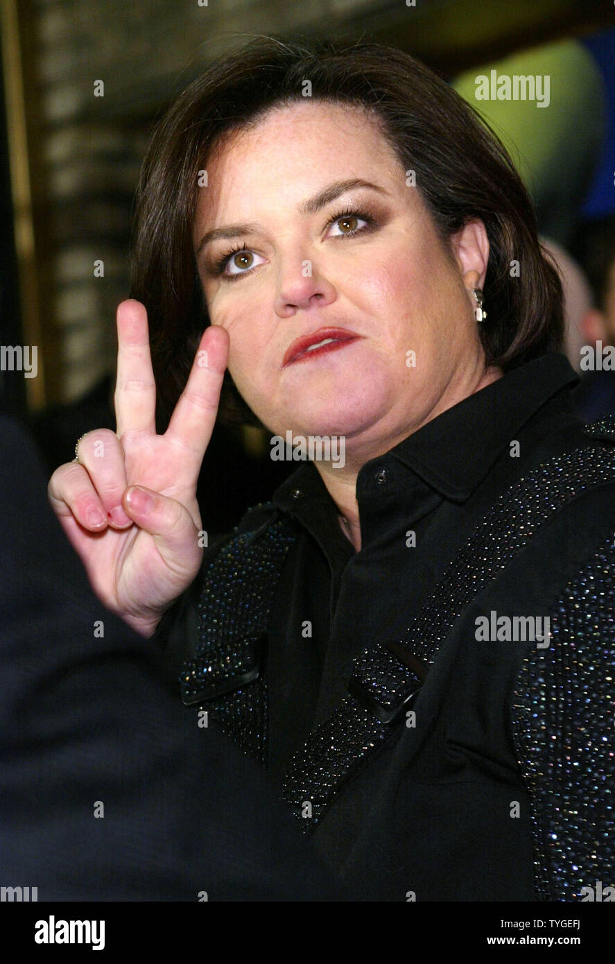 Former talk-show host and comedian Rosie O'Donnell gives the 'peace sign' as she arrives for  opening night of her Broadway production 'Taboo' on November 13, 2003 in New York City. The play, featuring Boy George, is about the counter culture of the 1980's.  (UPI/MONIKA GRAFF) Stock Photo