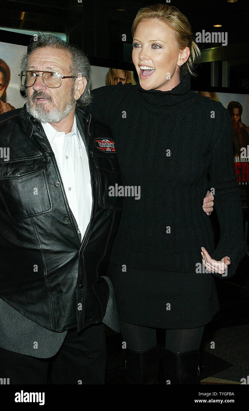 Charlize Theron (who plays Aileen Wuornos) and Al Bulling (Wuornos' best friend in real life) pose for pictures at the premiere of 'Monster!' at the Chelsea West Theater in New York on December 17, 2003.   (UPI Photo/Laura Cavanaugh) Stock Photo