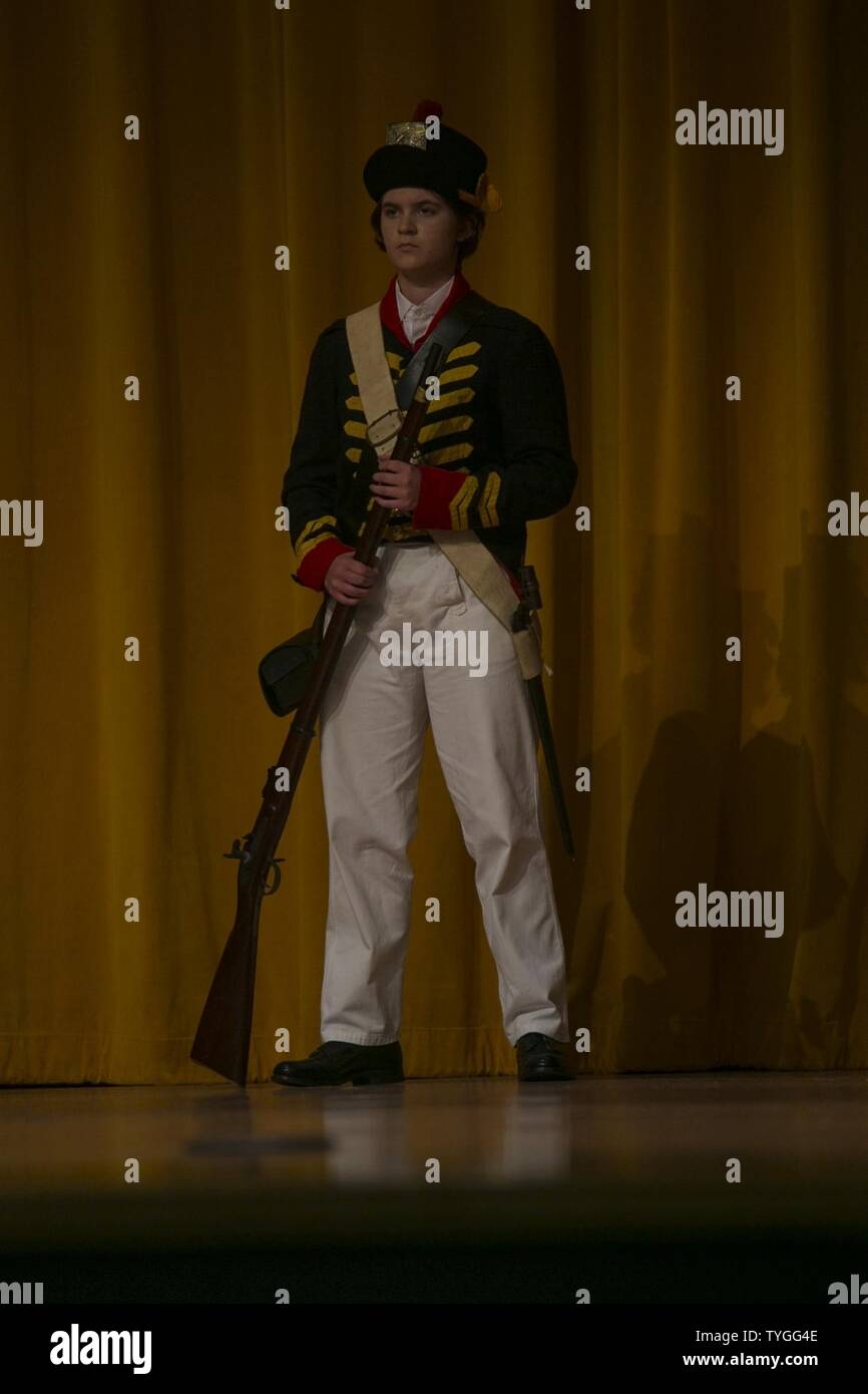 A Kubasaki High School Junior Reserve Officer Training Corps cadet models  the uniform worn by the Marines who fought in the War of 1812 during a  Marine Corps birthday uniform pageant Nov.