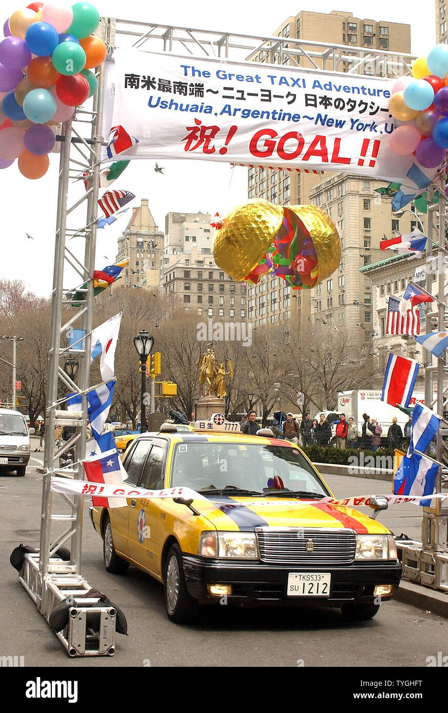 Japanese cab driver Tsyuyoshi Sakuma crosses the finish line outside the Plaza Hotel in New York City on April 2, 2004 after driving his cab from Ushuaia, Argentina on Dec. 23, 2003 to the United States.  (UPI/Ezio Petersen) Stock Photo