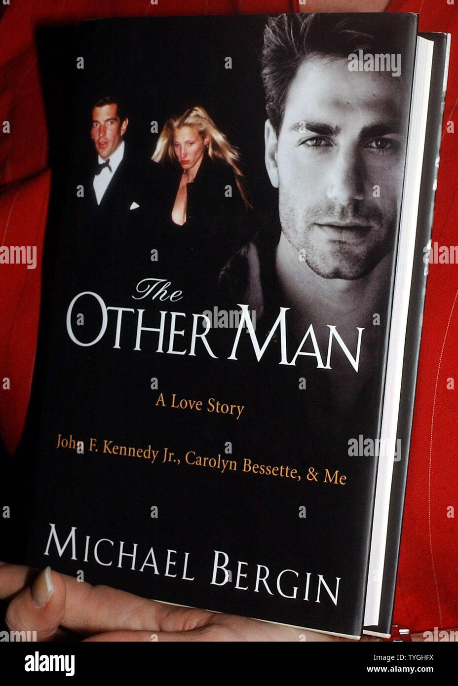 A publicist holds a copy of Michael Bergin tell all book 'The Other Man' a love story John F. Kennedy Jr., Carolyn Bessette and Me. (UPI/Ezio Petersen) Stock Photo