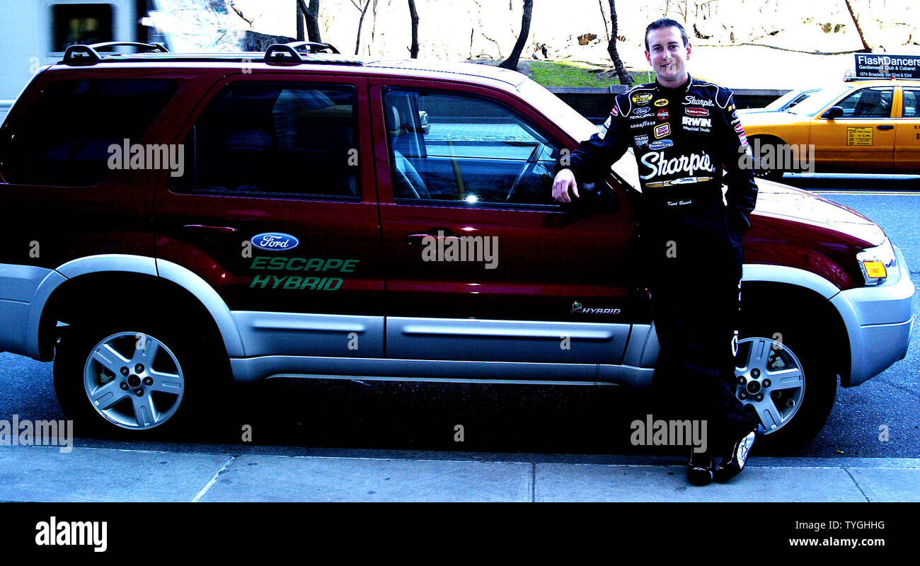 NASCAR Driver Kurt Busch poses with the new Ford Escape Hybrid Car in New York on April 6, 2004.   (UPI Photo/Laura Cavanaugh) Stock Photo