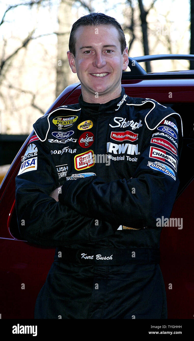 NASCAR Driver Kurt Busch poses with the new Ford Escape Hybrid Car in New York on April 6, 2004.   (UPI Photo/Laura Cavanaugh) Stock Photo