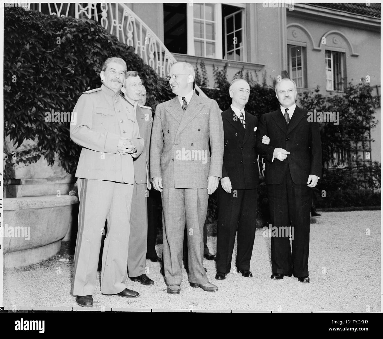 President Truman and Soviet Union Prime Minister Josef Stalin on the lawn in front of Prime Minister Stalin's residence during the Potsdam Conference, Potsdam, Germany. L to R: Prime Minister Josef Stalin, V. N. Pavlov, interpreter for Prime Minister Stalin, President Harry S. Truman, Secretary of State James Byrnes, and Soviet foreign minister Vyacheslav Molotov. Stock Photo