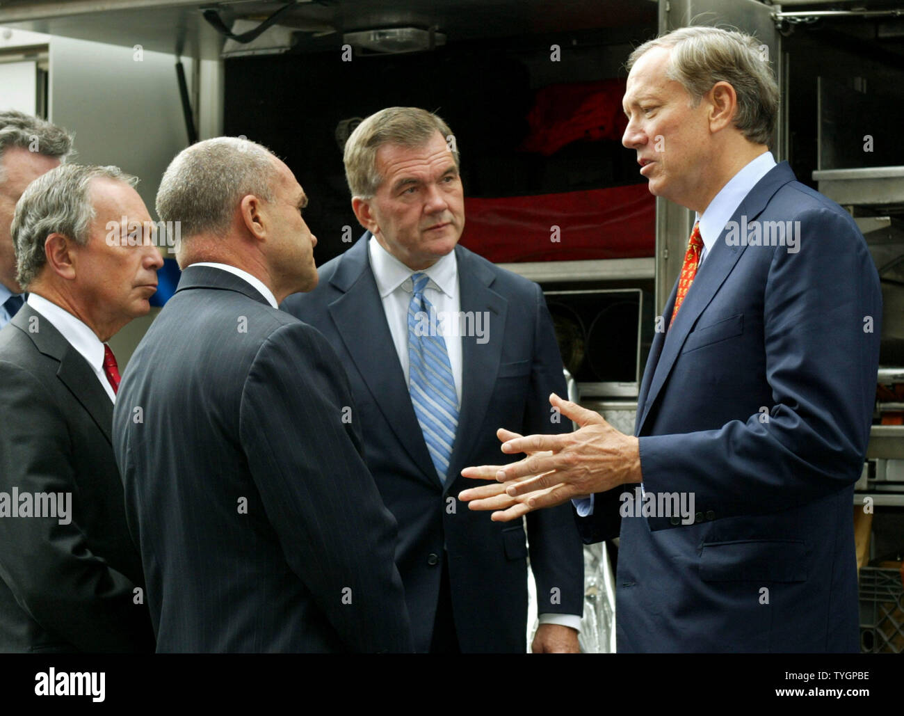 New York State governor George Pataki (R) talks with New York City mayor Michael Bloomberg (L), police commissioner Raymond Kelly (2nd L), and Secretary of Homeland Security Tom Ridge as they check out some of the security vehicles and apparatus at the New York City Police Department's headquarters August 25, 2004 in New York City. Ridge is on hand to discuss security measures with city officials in preparation for the Republican National Convention and the demonstrators it will attract to the city. (UPI Photo/Monika Graff) Stock Photo