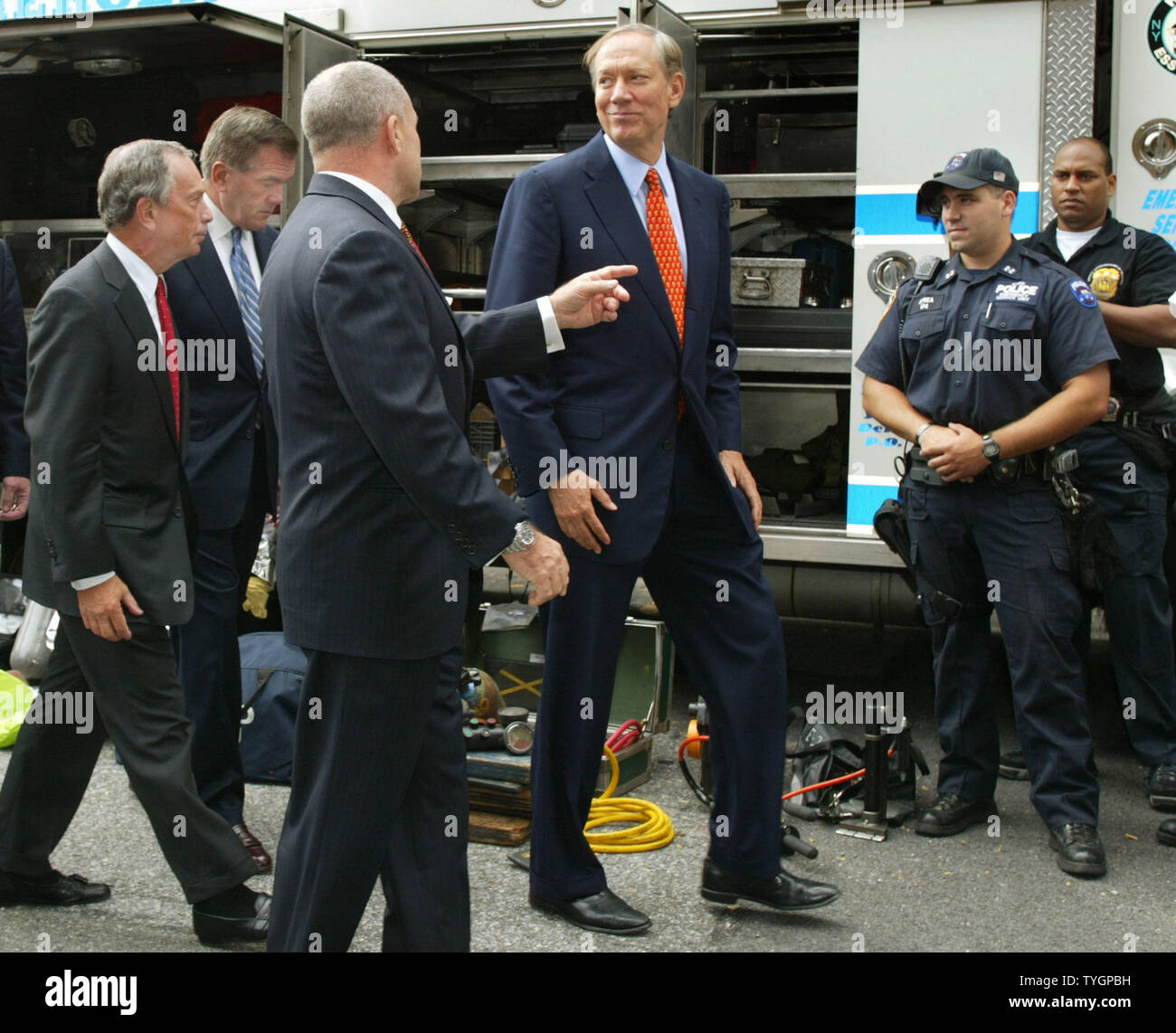 New York City police commissioner Raymond Kelly, center, gives mayor Michael Bloomberg, left, secretary of Homeland Security Tom Ridge, second left, and New York State governor George Pataki a tour of the special security vehicles and apparatus at the New York City Police Department's headquarters August 25, 2004 in New York City. Ridge is on hand to discuss security measures with city officials in preparation for the Republican National Convention and the demonstrators it will attract to the city. (UPI Photo/Monika Graff) Stock Photo