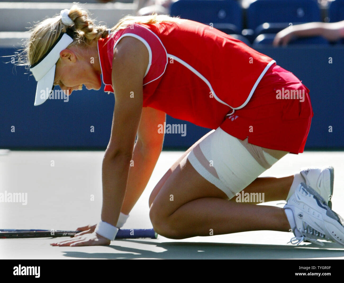 Elena Dementieva of Russia winces in pain as she plays with an injured leg  against top seeded Amelie Mauresmo of France at the 2004 US Open held at  the National Tennis Center