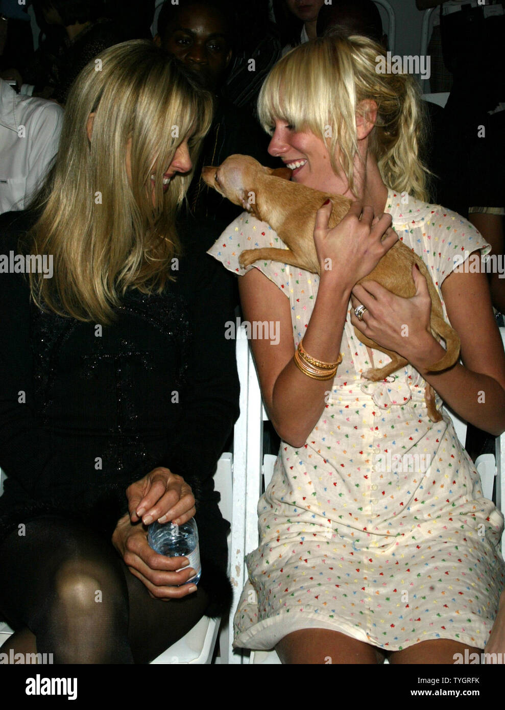 Kimberly Stewart cuddles with 'Prudence' (a friend's dog) as her mother Alana Stewart looks on at the Zang Toi Fashion Show at Bryant Park in New York on September11, 2004.  (UPI Photo/Laura Cavanaugh) Stock Photo