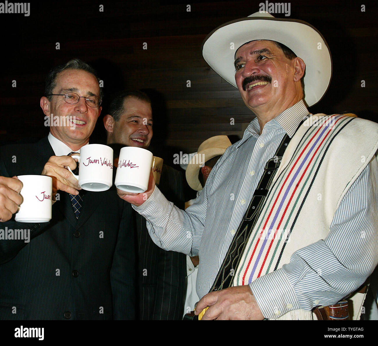 Colombian President Alvaro Uribe (L) and Juan Valdez, the icon of Colombian coffee, toast with coffee cups at the opening of the Juan Valdez Cafe in New York in New York on September 28, 2004.  (UPI Photo/Laura Cavanaugh) Stock Photo