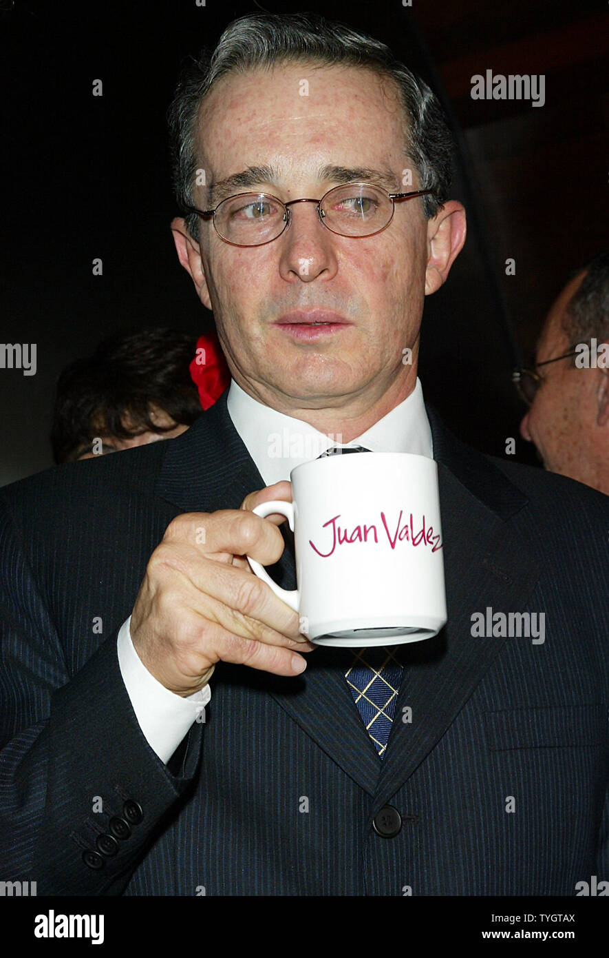 Colombian President Alvaro Uribe poses for pictures at the opening of the Juan Valdez Cafe in New York in New York on September 28, 2004.  (UPI Photo/Laura Cavanaugh) Stock Photo