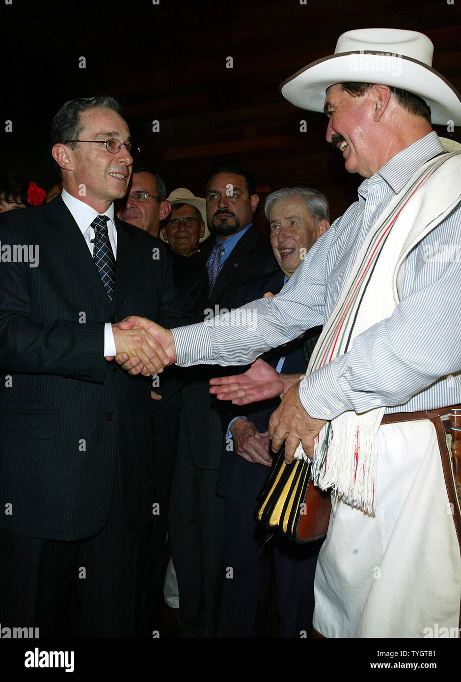 Colombian President Alvaro Uribe (L) and Juan Valdez, the icon of Colombian coffee, pose for pictures at the opening of the Juan Valdez Cafe in New York in New York on September 28, 2004.  (UPI Photo/Laura Cavanaugh) Stock Photo