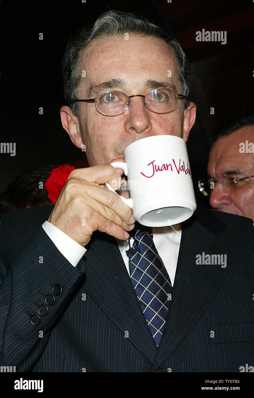 Colombian President Alvaro Uribe poses for pictures at the opening of the Juan Valdez Cafe in New York in New York on September 28, 2004.  (UPI Photo/Laura Cavanaugh) Stock Photo