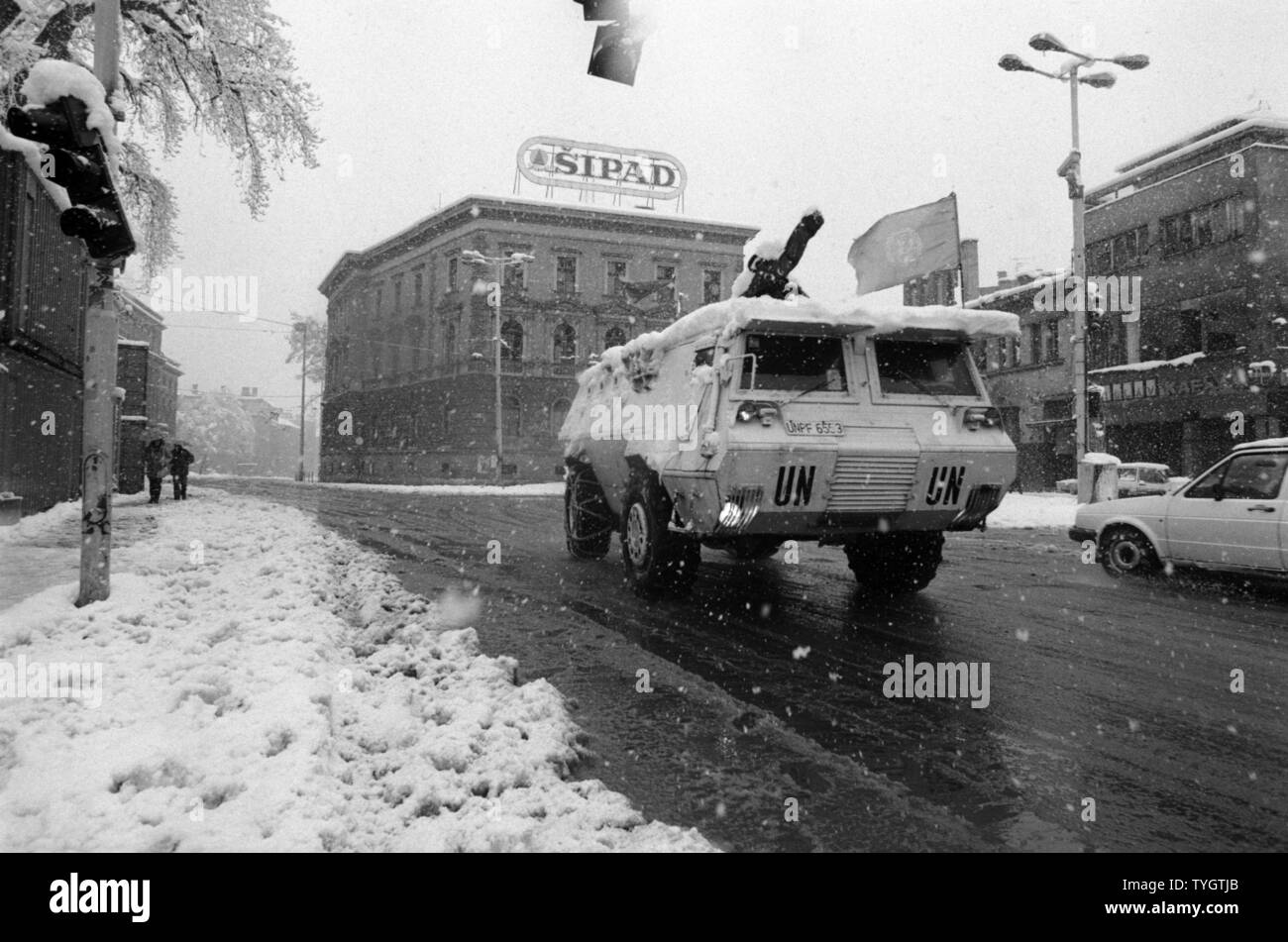 26th March 1993 During the Siege of Sarajevo: an Egyptian Fahd APC (armoured personnel carrier), part of the United Nations forces of UNPROFOR, drives through falling snow on Marsala Tita Street. Stock Photo