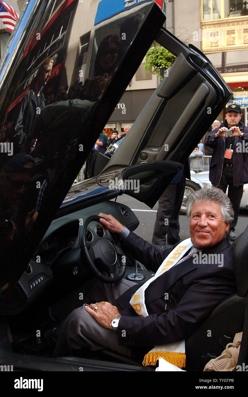 Reknown race car driver Mario Andretti serving as Grand Marshall waits to lead the 60th annual Columbus Day Parade up New York City's 5th Avenue on Oct. 11, 2004 in his Lamborgdini race car. (UPI Photo/Ezio Petersen) Stock Photo