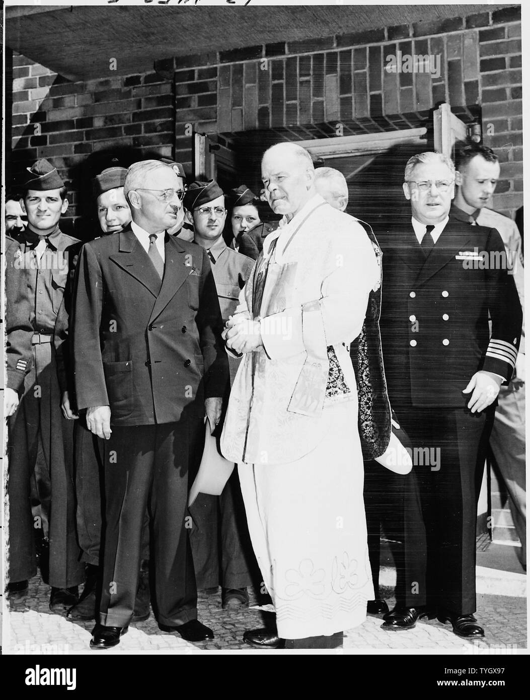 President Truman with Father L. Curtis Tiernan, Chief Chaplain of the United States Army Forces of the European Theater. The President had attended Catholic mass at ll:30 a.m. Father Tiernan had known President Truman from World War I when Father Tiernan was the chaplain for the 129th Field Artillery of the 35th Division ( in which Harry Truman served). Stock Photo