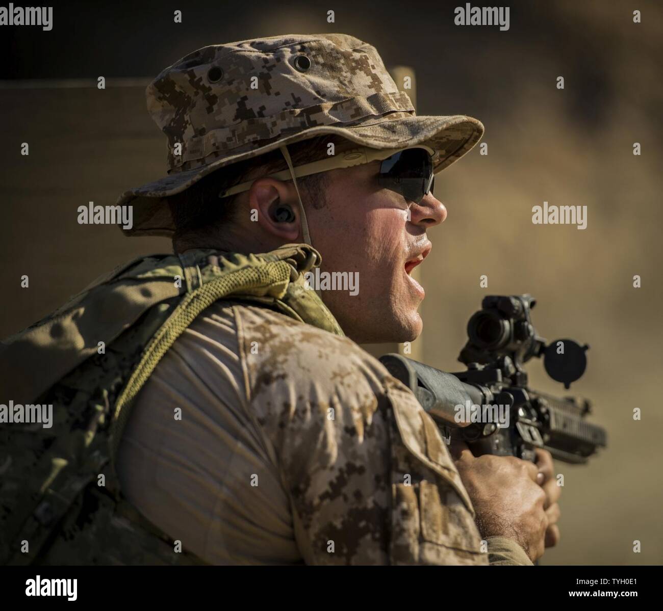 Petty Officer 1st Class Joshua Keim, assigned to Naval Special Warfare Group TWO, participates in a combat shooting course during Fleet Combat Camera Pacific's Winter Quick Shot, Nov. 9, 2016, in Azusa, Calif. Quick Shot is a biannual exercise that provides live-fire and scenario based training to combined joint combat camera assets. Stock Photo