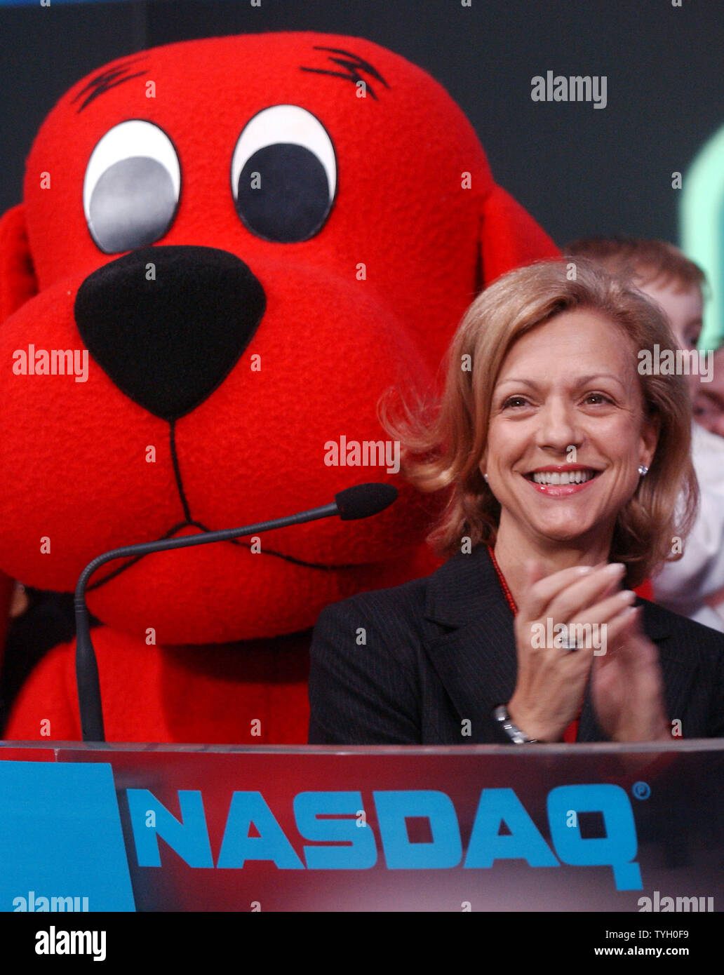 Deborah Forte, President of Scholastic Entertainment is joined by their  most famous book characther Clifford The Big Red Dog and Bob Greifeld, CEO  of NASDAQ at the 2/14/05 ceremonial NASDAQ opening bell