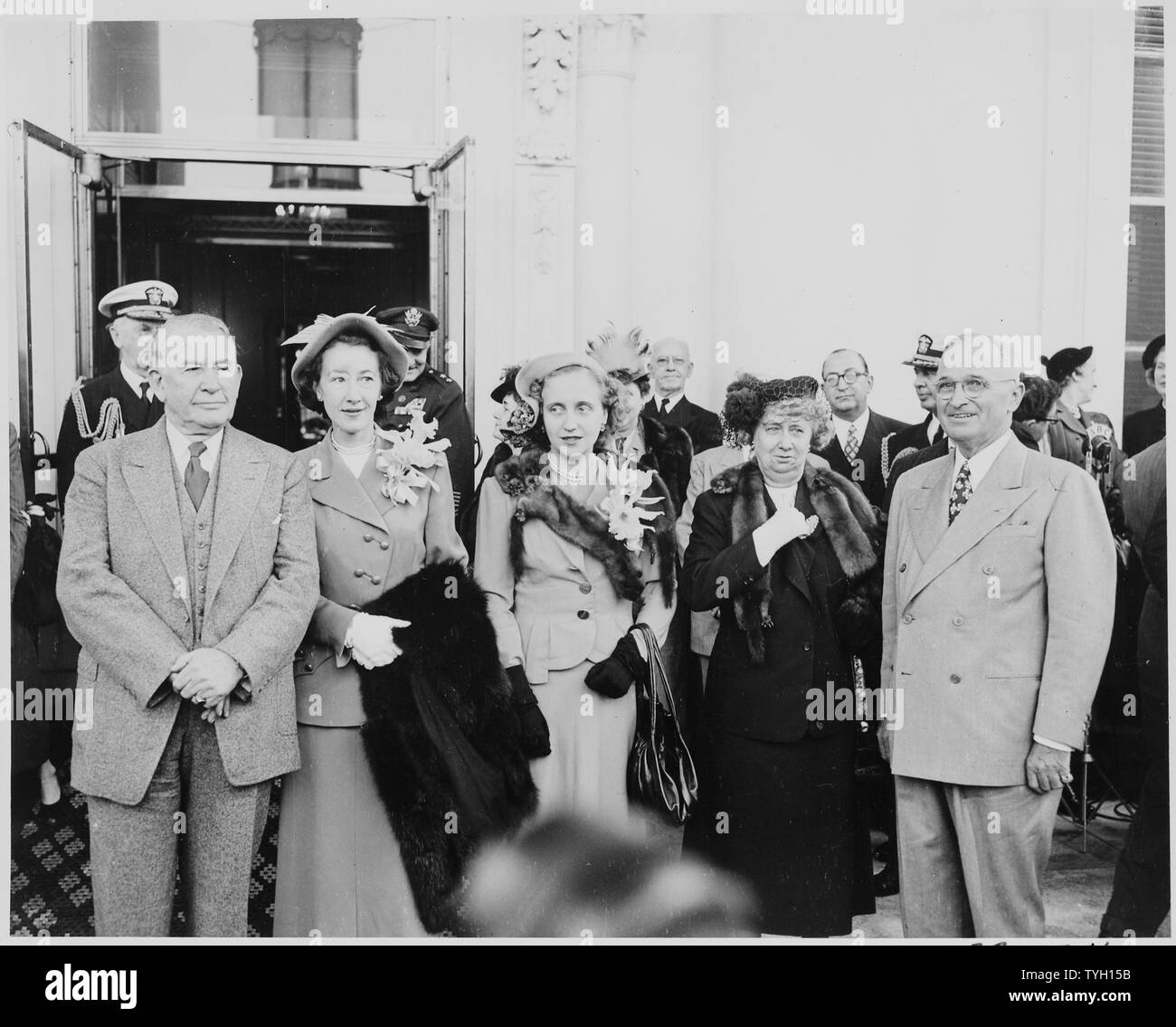 President and Mrs. Harry S. Truman, Alben W. Barkley, Mrs. Max Truitt, and Margaret Truman posing together, with other dignitaries standing behind them. President Truman and Vice President-elect Barkley had just returned to Washington after winning the election of 1948. Stock Photo