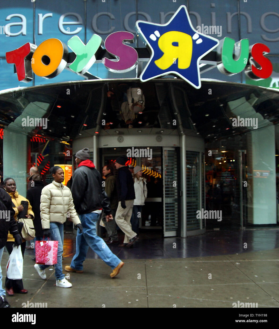 People walk past the New York flagship store for Toys R Us. in Times  Square. The New Jersey based Toys R Us Inc. was purchased on March 17, 2005  for $5.7 billion