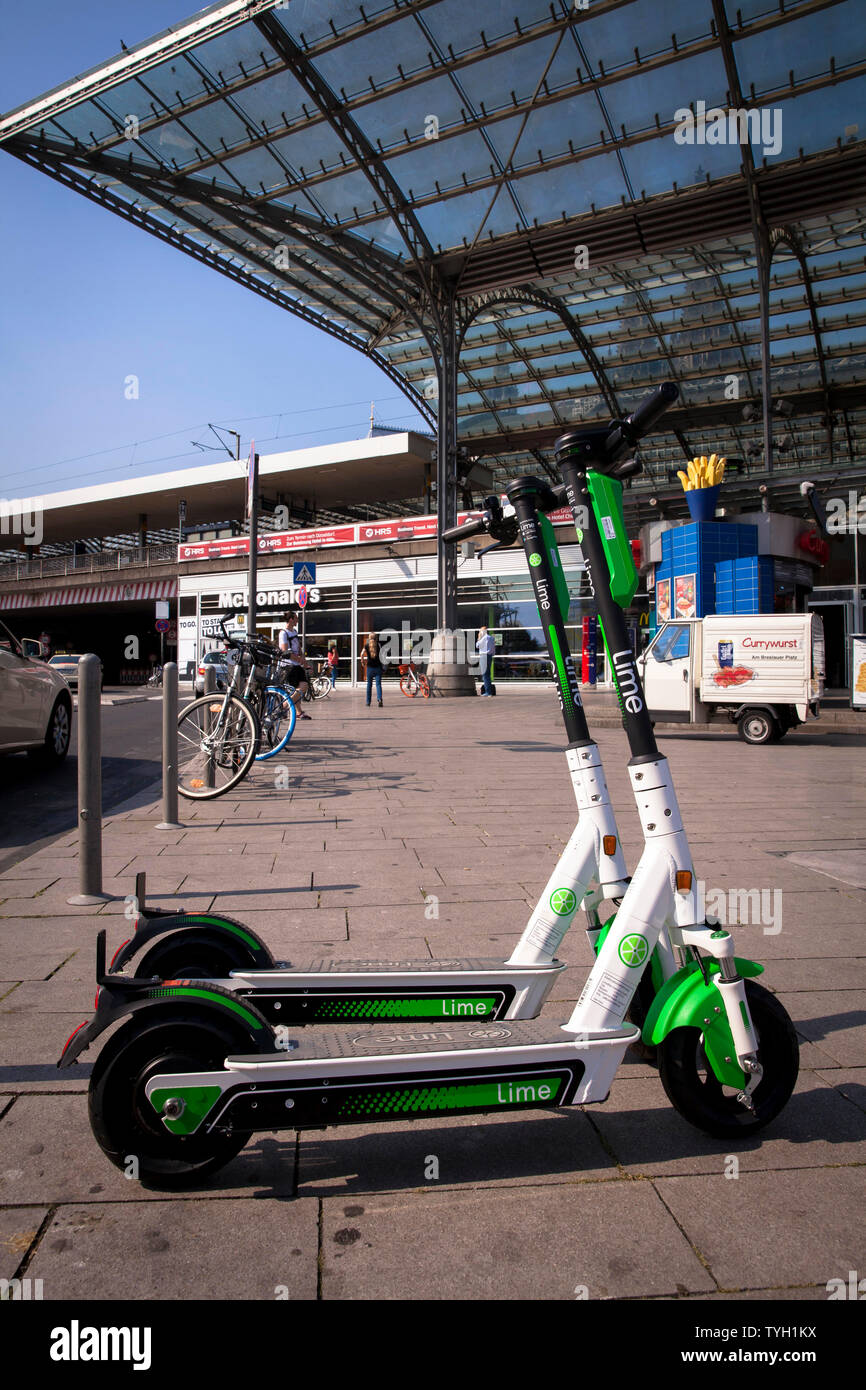 Lime-S electric scooters for rental at the main station, Cologne, Germany.  Lime-S Elektroscooter zum mieten am Hauptbahnhof, Koeln, Deutschland. Stock Photo