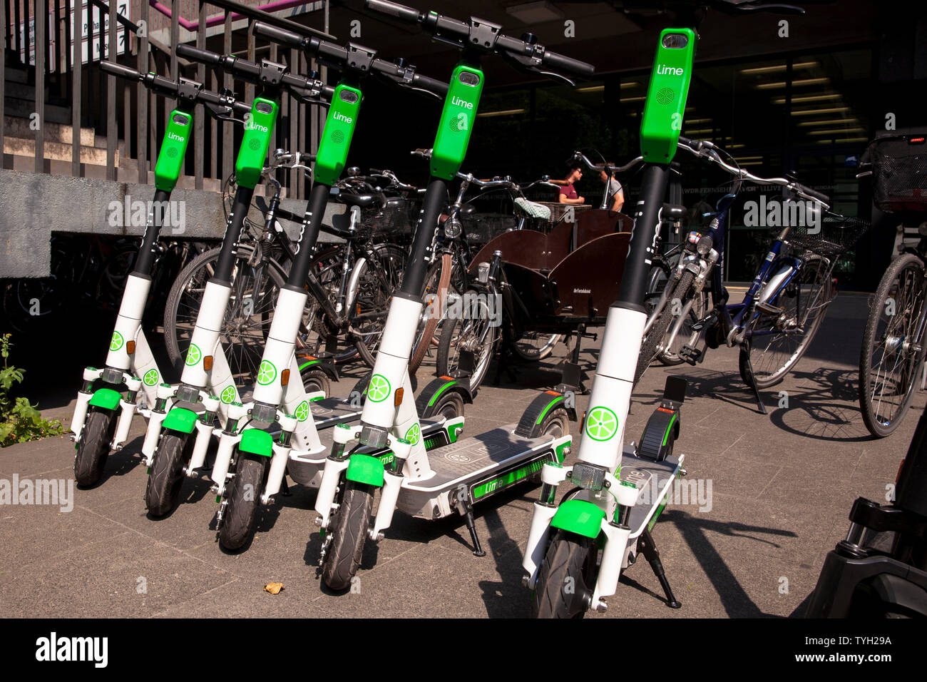 Lime-S electric scooters for rental in the city, Cologne, Germany.  Lime-S Elektroscooter zum mieten in der Innenstadt, Koeln, Deutschland. Stock Photo