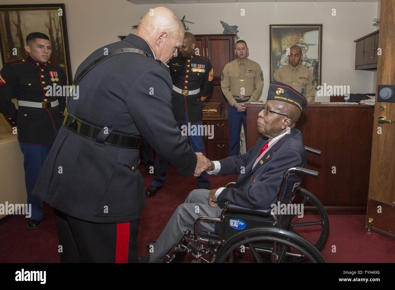 Commandant of the Marine Corps Gen. Robert B. Neller, left, shakes hands with retired Staff Sgt. Charles G. Manuel, Jr., before a cake cutting ceremony in observance of the Marine Corps’ birthday, Arlington, Va., Nov. 9, 2016. Manuel, 93, served in the U.S. Marine Corps from 1942 to 1946 and was the oldest Marine present at the ceremony. Stock Photo