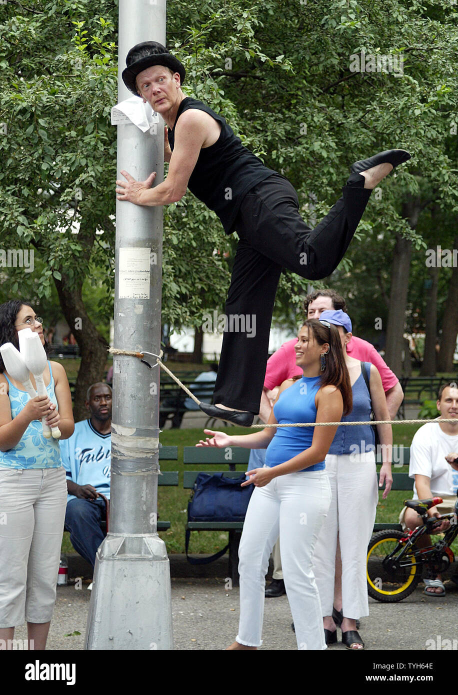 French aerialist Philippe Petit performs in Washington Square Park in New York on July 30, 2005.  The performance is part of the commemoration of the anniversary of his 1974 tightrope walk between the World Trade Center towers.   (UPI Photo/Laura Cavanaugh) Stock Photo