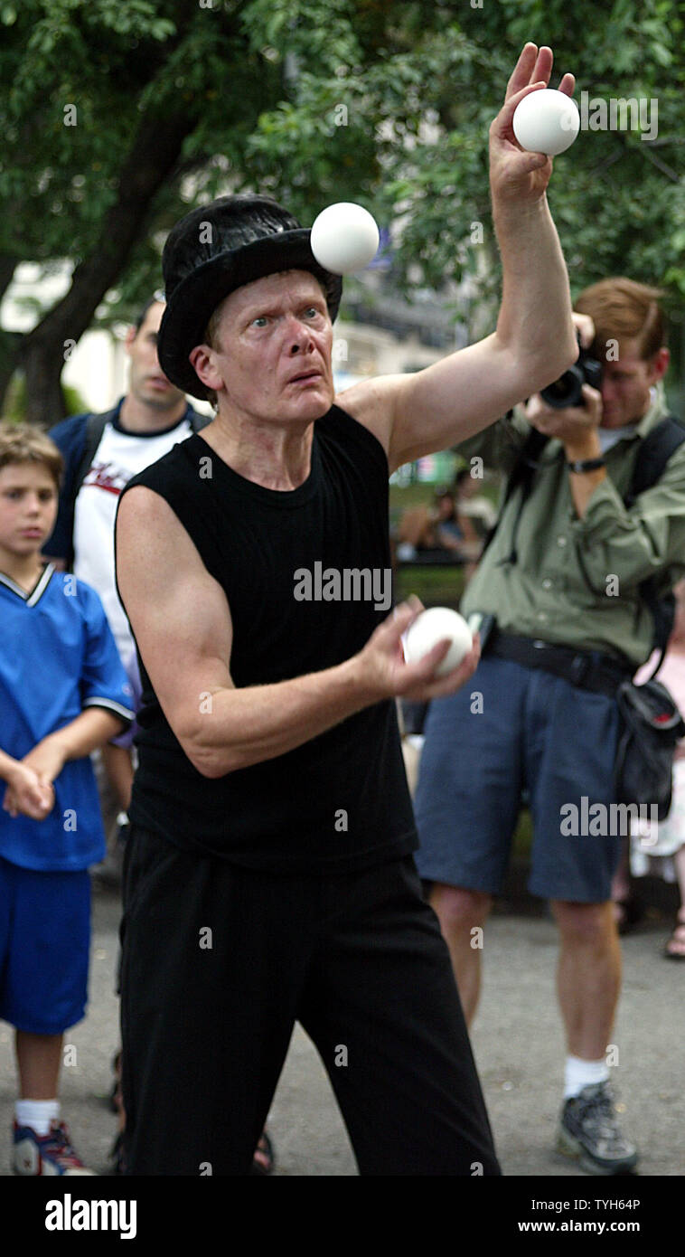 French aerialist Philippe Petit performs in Washington Square Park in New York on July 30, 2005.  The performance is part of the commemoration of the anniversary of his 1974 tightrope walk between the World Trade Center towers.   (UPI Photo/Laura Cavanaugh) Stock Photo