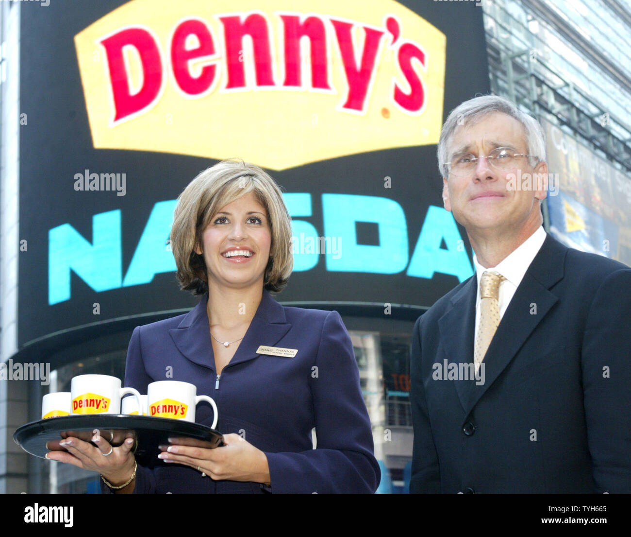 thannya-beck-general-manager-for-denny-s-and-nelson-marchioli-ceo-and-president-of-the-restaurant-chain-stand-before-nasdaq-s-giant-video-screen-in-time-square-after-marchioli-rang-the-opening-bell-at-the