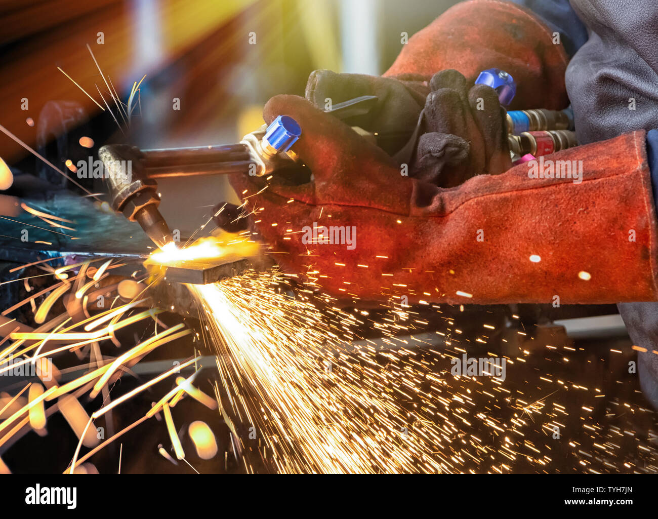 african man with a cutting torch in a factory working Stock Photo