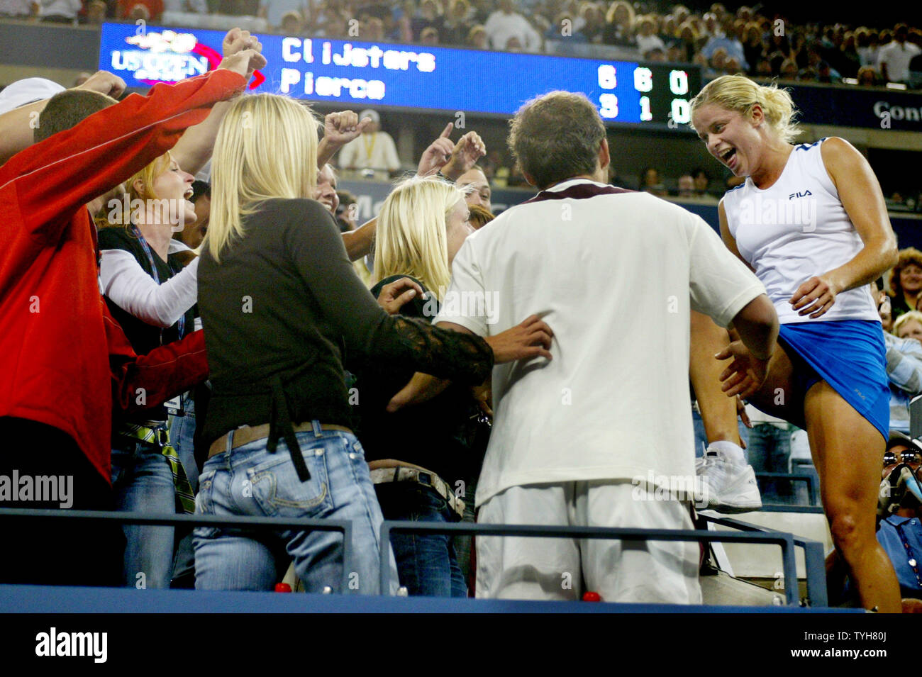 Kim Clijsters Of Belgium Right Climbs Into The Stands Where Her Family And Friends Are Sitting After She Clenched The Women S Championship Title By Defeating Mary Pierce At The Us Open Tennis
