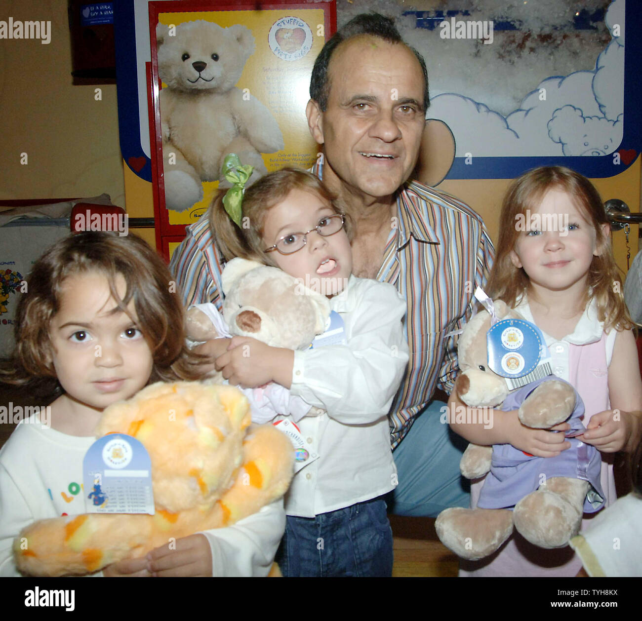 New York Yankee's manager Joe Torre poses with children who joined
