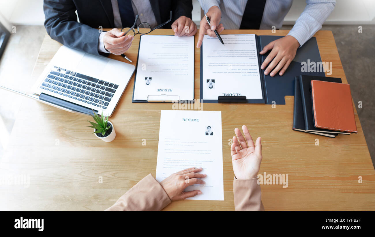 businessman professional women - Businessman Professional Women In Suit Explaining About Her Profile To Business Managers Holding Reading A Resume Interview The Job Hiring Career And TYHB2F 