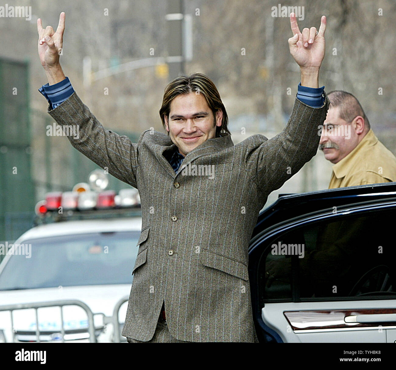 Johnny Damon, with his new, short hair cut, gestures to fans before  attending a press conference where he is introduced as the newest member of  the New York Yankees team at Yankee