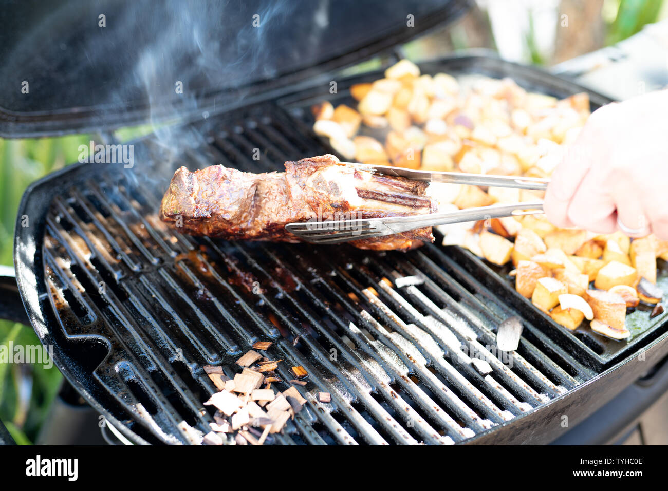 Steak and potato chunks cooking on a outdoor grill Stock Photo Alamy