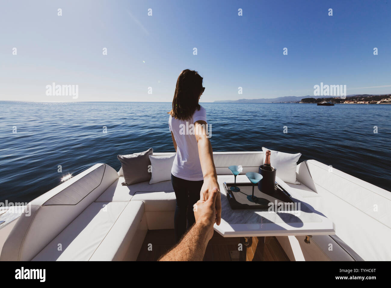 woman holding man's hand on luxury yacht on the sea Stock Photo