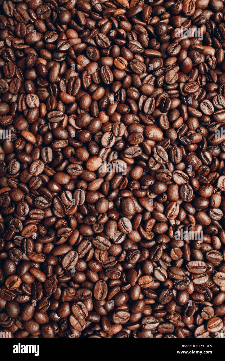 Roasted coffee beans brown seeds texture background wallpaper Stock Photo -  Alamy