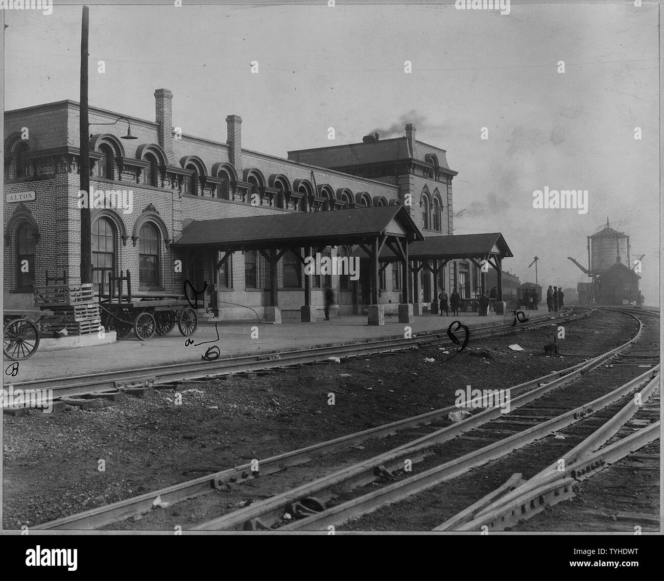 Railroad station. Alton, Illinois; Scope and content:  Views of the station showing tracks, water tank, baggage carts, and electric trolley car. Stock Photo