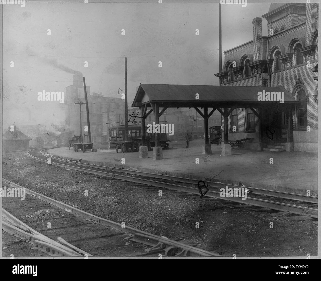 Railroad station. Alton, Illinois; Scope and content:  Views of the station showing tracks, water tank, baggage carts, and electric trolley car. Stock Photo