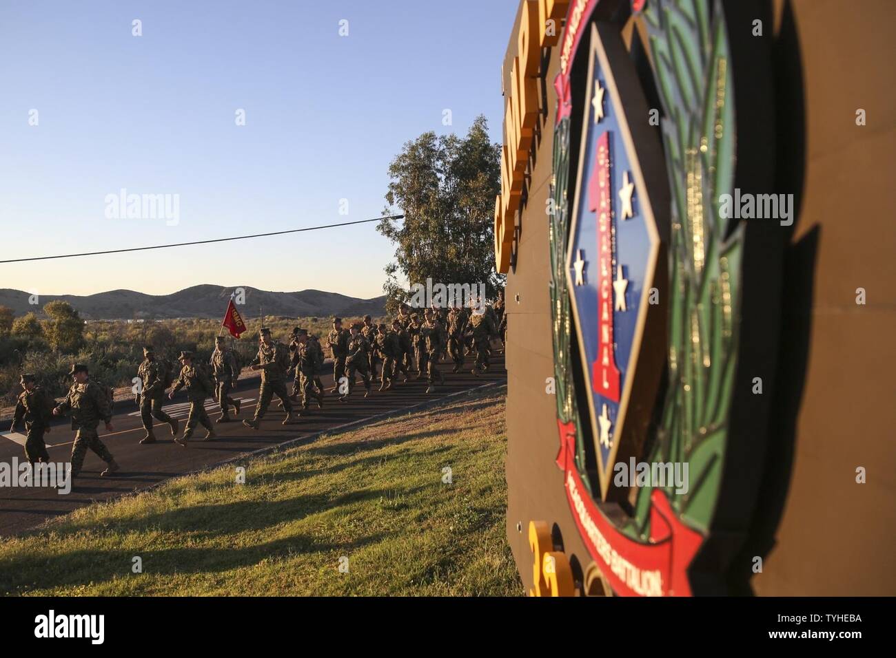 Marines with Headquarters Battalion, 1st Marine Division, hike pass the ...