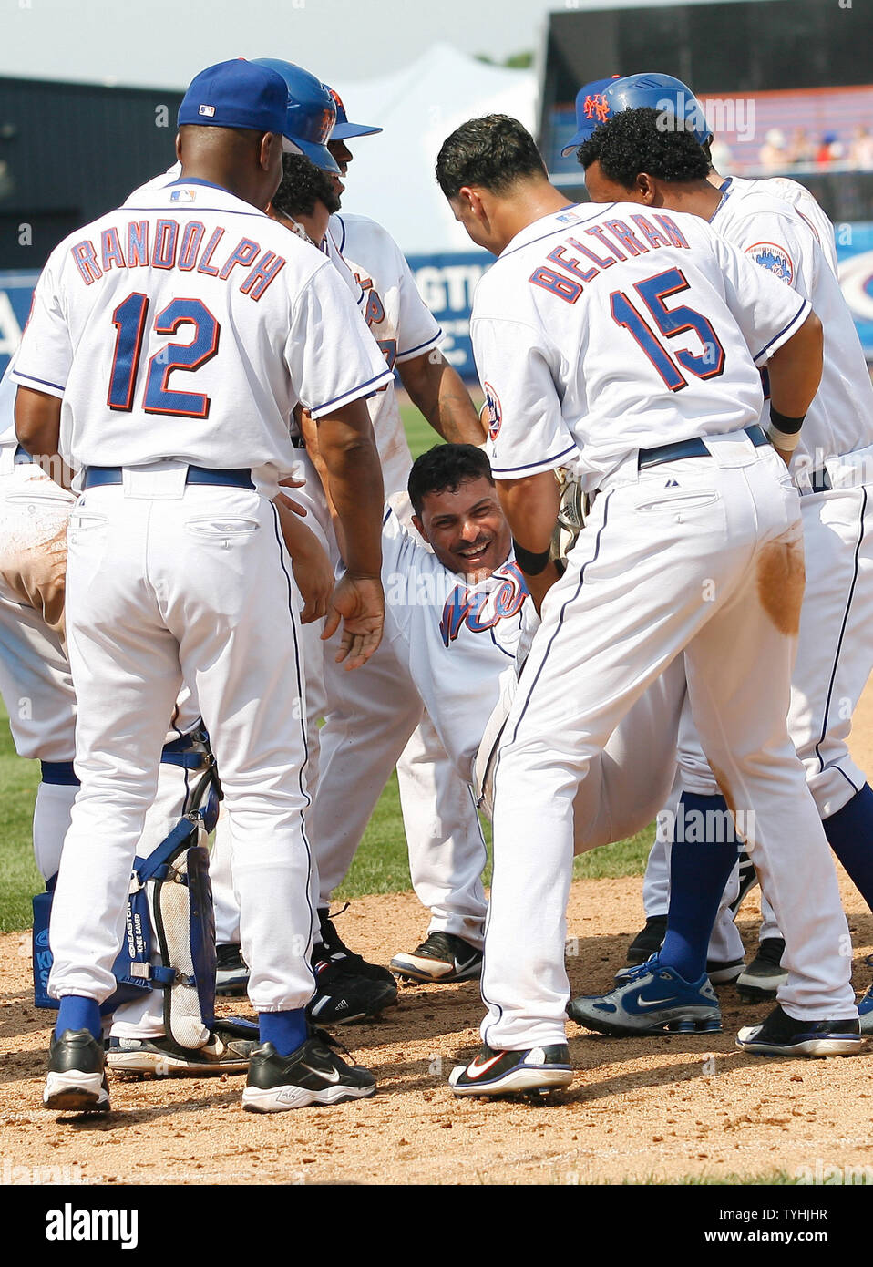 New York Mets Jose Valentin gets lifted and draged by his