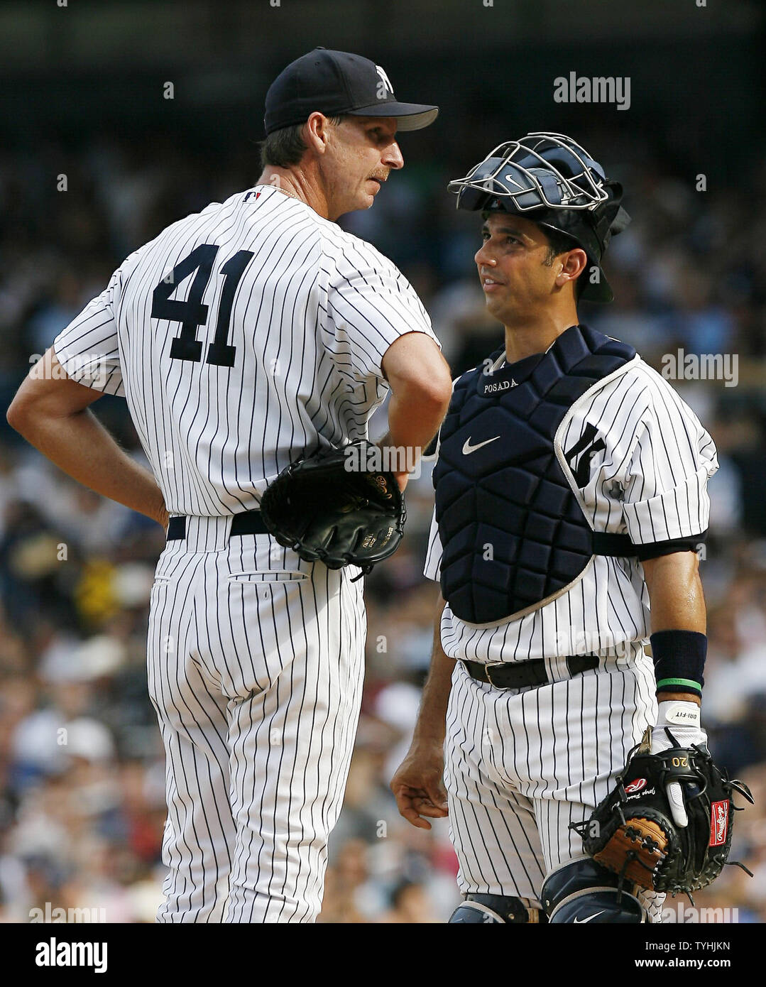 New York Yankees Randy Johnson and Jorge Posada talk on the mound after a 3  run homer by Tampa Bay Devil Rays Damon Hollins in the third inning at  Yankees Stadium in