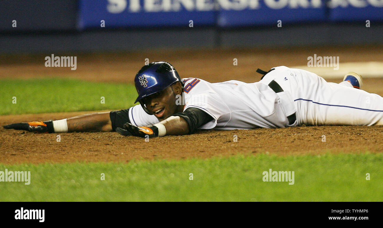 New York Mets Jose Reyes smiles during a slide into home plate after ...